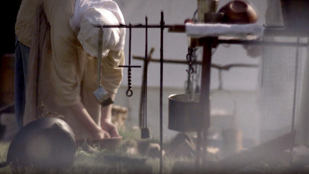 Screenshot of a woman working from the American Revolution film